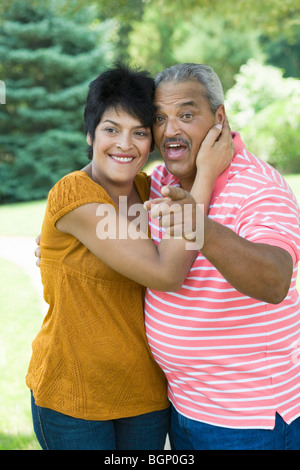 Side profile of a mature woman embracing a senior man and smiling Stock Photo