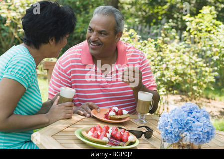 Side profile of a mature woman sitting with a senior man at the breakfast table Stock Photo
