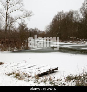 A view from the bank of the ice-covered River Stour in Suffolk. Stock Photo