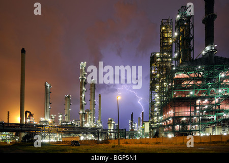 Lightning during thunderstorm above petrochemical industry in the Antwerp harbour at night, Belgium Stock Photo