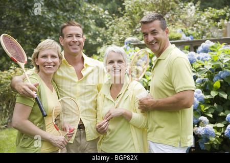 Portrait of two mature couples standing in a park Stock Photo