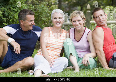 Two mature couples sitting in a park Stock Photo