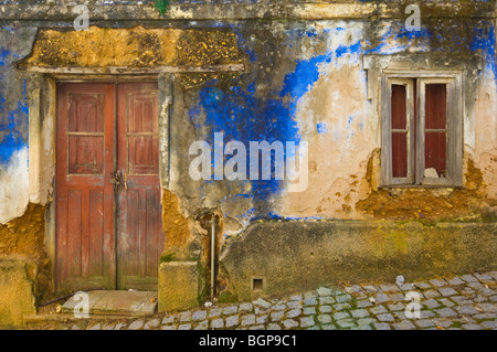 Old walls and door of a ruined blue painted cottage in the village of AljezurAlgarve district Portugal EU Europe Stock Photo