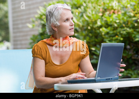 Mature woman working on a laptop Stock Photo