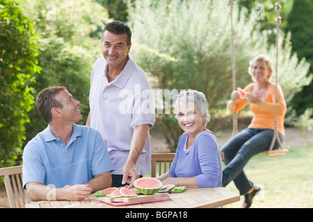Two mature couples in a lawn Stock Photo