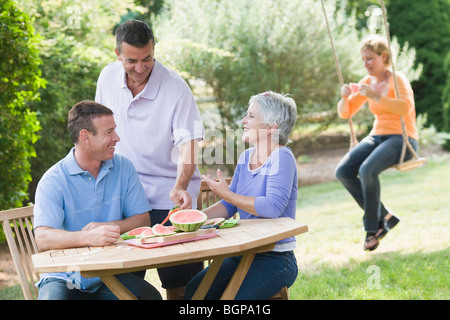 Two mature couples in a lawn Stock Photo