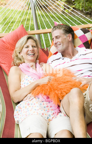 Mature couple lying in a hammock and smiling Stock Photo