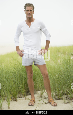Portrait of a mature man standing on the beach Stock Photo
