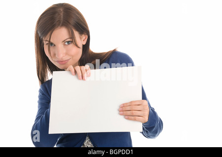 Portrait of young casual businesswoman holding blank note card isolated on white background Stock Photo