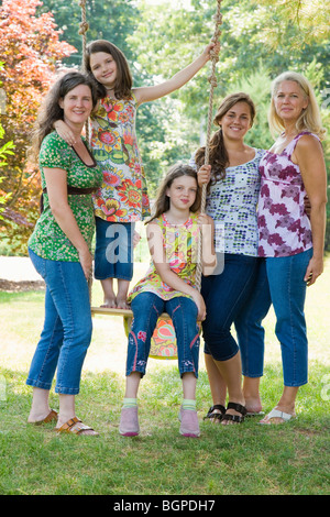 Two families in a garden and smiling Stock Photo