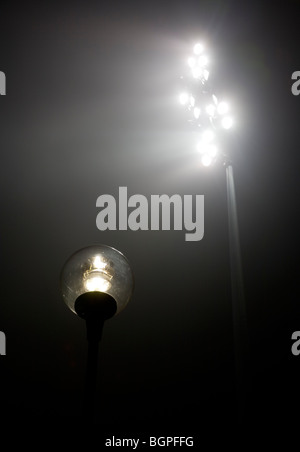 Lit stadium lights and streetlamp at night , Finland Stock Photo