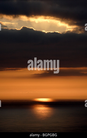 The sun sets over the atlantic ocean Stock Photo