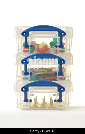 Drawing pins and paper clips in small plastic boxes stacked in threes Stock Photo
