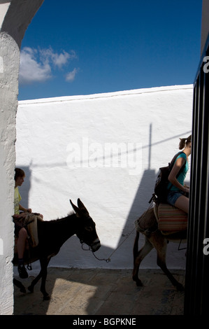 Tourist rides up the hill on a donkey at Lindos Village, Rhodes, Greece Europe EU Stock Photo