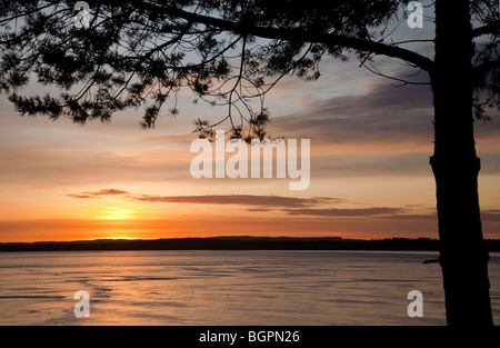 Ice covered lake at sunset at Winter , Finland Stock Photo