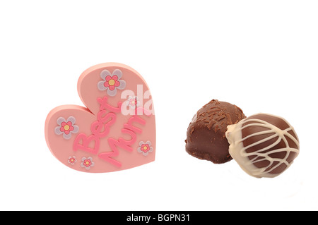 Heart shaped mothers day badge showing BEST MUM on white background with two chocolates, Ideal for greeting card Stock Photo