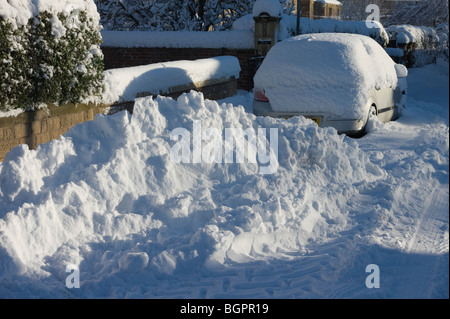 Winter January 2010 Scotland - Kelso Scottish Borders. Pile of snow on side road with car covered in snow. Stock Photo