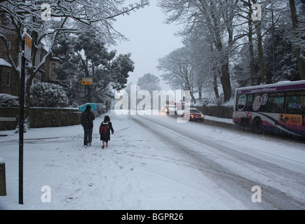 Mother and daughter walking to school in extreme winter weather, Ecclesall Road, Sheffield in January 2010 Stock Photo