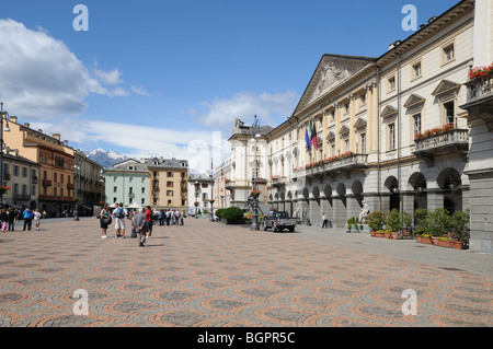 Plaza Emilio Chanoux with town hall on right in Aosta Italy Gran Paradiso range of alpine mountains in distance Stock Photo