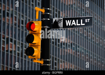 A street sign for Wall Street, in front of one of the many skyscrapers and buildings in New York city's financial district. Stock Photo