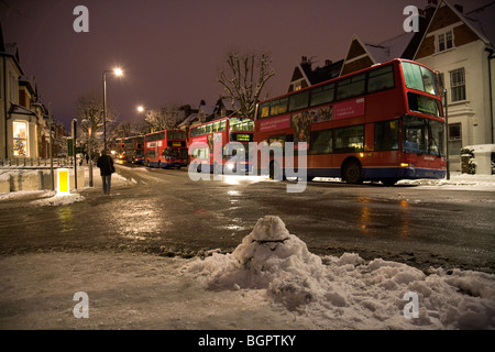 A line of out-of-service buses parked along Muswell Hill Road during the record-breaking icy cold spell in London, January 2010 Stock Photo
