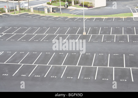 large, numbered, empty parking lot with offset spaces Stock Photo