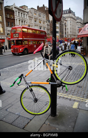 Bicycle locked on a street pole the strand London, England, Britain, UK Stock Photo