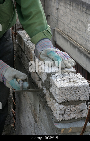 Bricklayer building a wall in Mexico City. Stock Photo