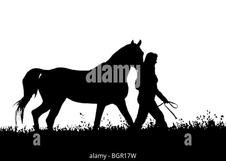 Stock photo of a woman walking her horse in RGB zero and 255 only, black and white silhouette. Stock Photo