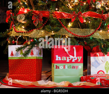Three gift boxes and a gift box under a home-decorated Christmas tree Stock Photo