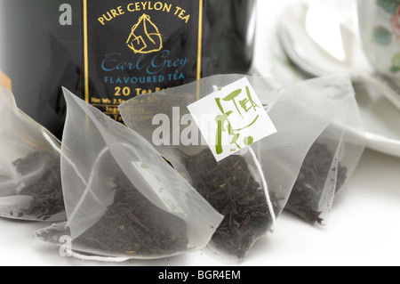 Teabags with Black Tea Leaves Stock Photo