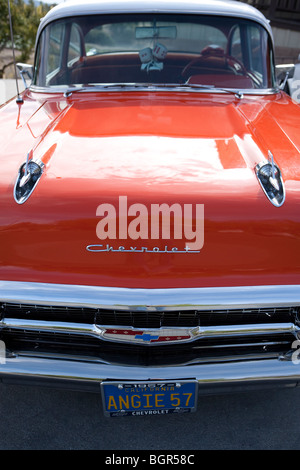 A 1957 Chevrolet sedan painted a bright redish orange and white in Santa Ynez, California Stock Photo