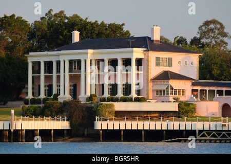 Very large pink mansion house glowing in the evening sun. Stock Photo