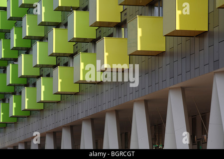 barking central learning centre and apartments, barking town square arcade with green and yellow balconies above Stock Photo