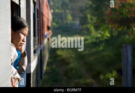 Burmese woman looking through the window. Train Shwenyaung-Thazi. Myanmar Stock Photo