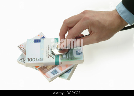 Hand with stethoscope doing a checkup on Euro banknotes Stock Photo