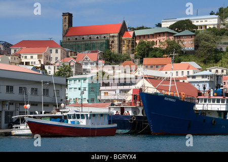 Fishing Boats Moored in the Carenage with the Red Roof of the Church and Harbourside Buildings, Saint George's, West Indies. Stock Photo