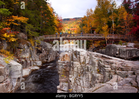 Walking bridge crossing the Rocky Gorge Falls along the Kancamagus Highway near Conway New Hampshire USA Stock Photo