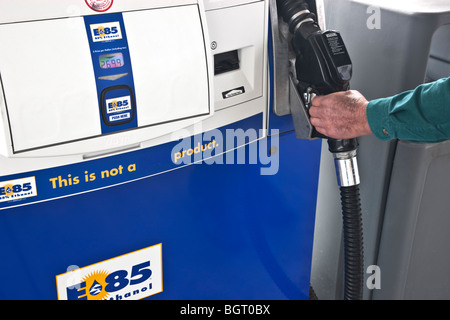 Hand removing nozzle, gasoline pump 'Flex Fuel' E85. Stock Photo