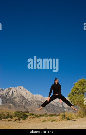 Girl jumping, sky in background Stock Photo - Alamy