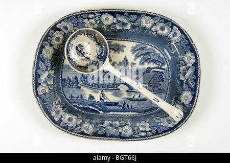19th C. English blue and white transfer printed pottery platter and ladle Stock Photo
