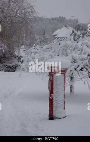 Freshly fallen snow on local pillar box Stock Photo