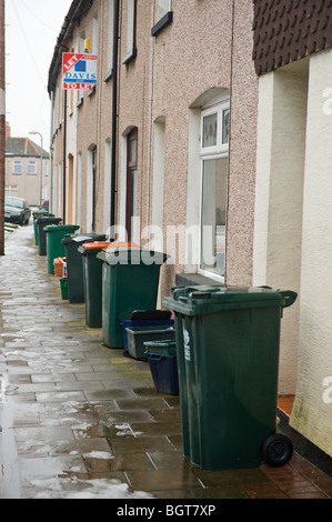 Wheelie bins on pavement outside terraced houses in Newport South Wales UK Stock Photo