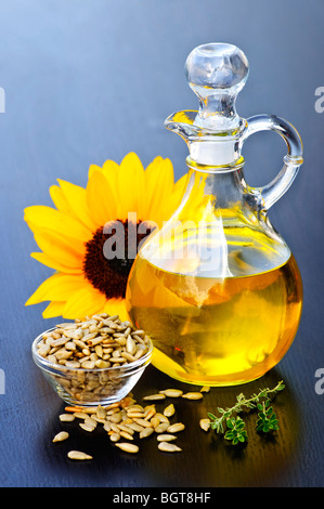 Sunflower oil bottle with raw seeds and flower Stock Photo