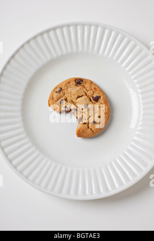 Single cookie on white plate Stock Photo