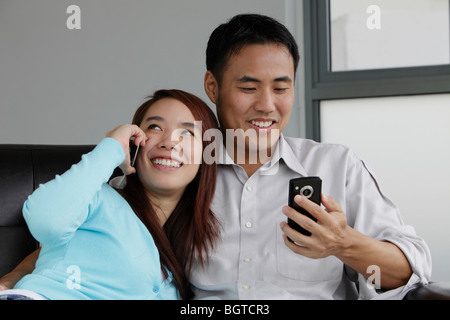 Young couple talking on their phones Stock Photo