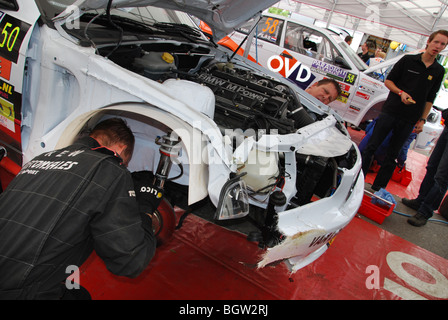 assessing accident damage on BMW rally car at at 2009 Dutch Paradigit-ELE rally Netherlands Stock Photo