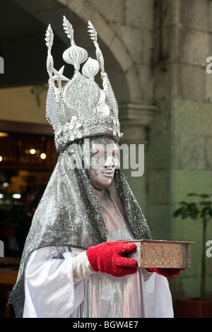 magical glittering silver costumed flame eyed king holding box of destinies performs in Sunday Zocalo Oaxaca City Mexico Stock Photo