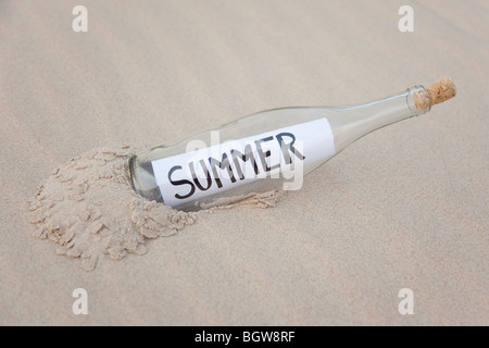 A clear glass bottle washed up on the beach Stock Photo