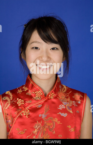 Beautiful young Asian girl posing for a portrait wearing a traditional Chinese dress Stock Photo